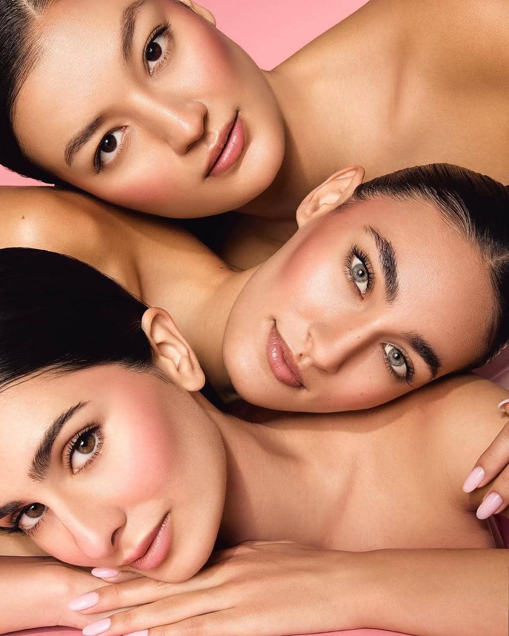 Three models in matching beauty campaign makeup for a studio shoot