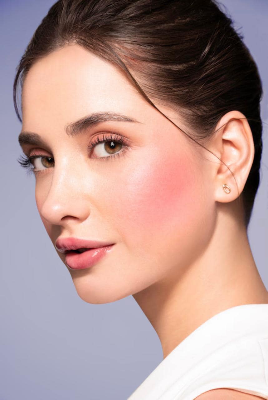 Editorial beauty look built on diffused blush across the cheeks and eyelids