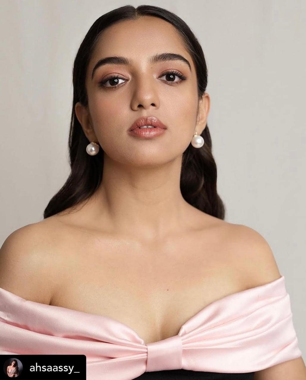 Soft rose-toned editorial portrait with dewy skin and a monochrome flush