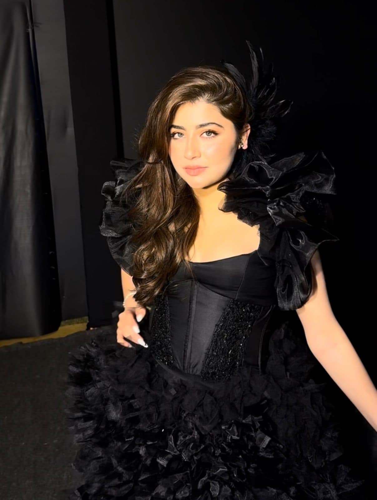 Dramatic evening glam in a black gown, with deep smokey eyes and defined brows